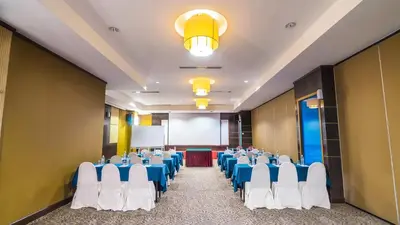 a conference room with blue and white chairs and a podium at Crystal Crown Hotel Kuala Lumpur in Kuala Lumpur
