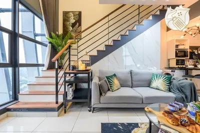 a living room with a couch and stairs at Luxury Duplex Condo Retreat-Corner v 2 Parking, KL by Verano in Kuala Lumpur