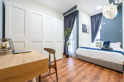 a bedroom with a bed and a desk with a laptop at Luxury Duplex Condo Retreat-Corner v 2 Parking, KL by Verano in Kuala Lumpur