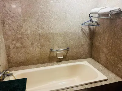 a bath tub in a bathroom with a sink at APARTMENT by Times Square KL in Kuala Lumpur