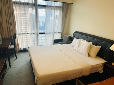 a hotel room with a bed and a large window at APARTMENT by Times Square KL in Kuala Lumpur