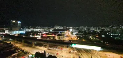 a city at night with a bridge and buildings at The Elements @ Ampang in Kuala Lumpur
