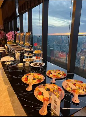 a buffet of pizzas on a table in a building at Star residance at Klcc - Two bedrooms with twin towers view in Kuala Lumpur