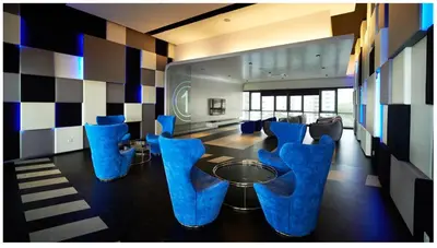 a living room with blue chairs and a table at The Elements Ampang Infinity Pool in Kuala Lumpur
