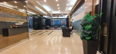 a lobby with a person sitting at a desk in a building at The Elements Ampang Infinity Pool in Kuala Lumpur