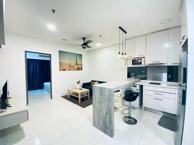 a kitchen with white cabinets and a counter top at Summer Suites Apartment 7min walk to KLCC by GRIHOZ in Kuala Lumpur