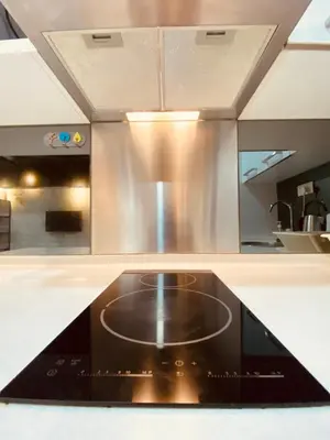 a kitchen counter with a stove top in a kitchen at Summer Suites Apartment 7min walk to KLCC by GRIHOZ in Kuala Lumpur