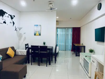 a living room with a couch and a table at Summer Suites Apartment 7min walk to KLCC by GRIHOZ in Kuala Lumpur
