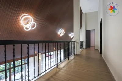 a hallway of a house with a staircase with wood paneling at KL Townhouse Villa by LilyandLoft in Kuala Lumpur