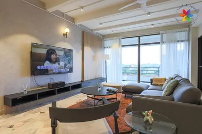a living room with a couch and a tv at KL Townhouse Villa by LilyandLoft in Kuala Lumpur