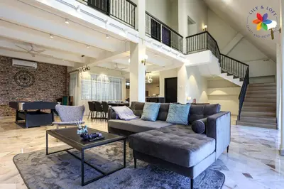 a living room with a couch and a table at KL Townhouse Villa by LilyandLoft in Kuala Lumpur