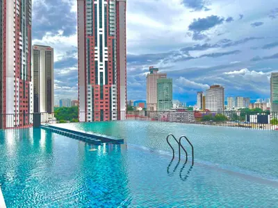a large pool of water in a city with tall buildings at Chambers Couple studio Klcc in Kuala Lumpur