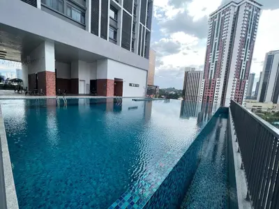 a large swimming pool in the middle of a city at Chambers Couple studio Klcc in Kuala Lumpur