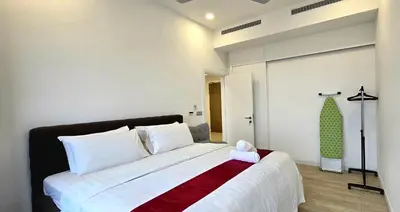 a bedroom with a large bed with a red and white blanket at Panoramic KLCC Lake view, M CITY Jalan Ampang in Kuala Lumpur