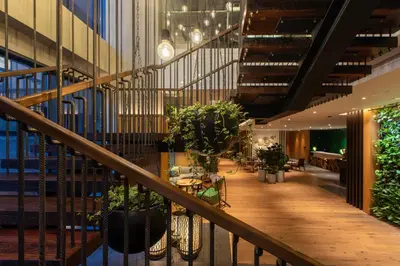 a staircase in a building with potted plants at Hotel Indigo Kuala Lumpur on the Park by IHG in Kuala Lumpur