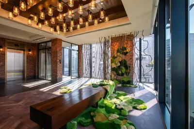 a living room with a bench and plants at Hotel Indigo Kuala Lumpur on the Park by IHG in Kuala Lumpur