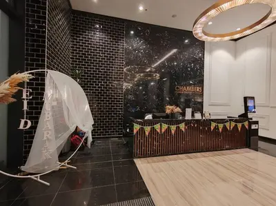 a room with a table and a mirror on the wall at Chambers Residence by FANTASTIC in Kuala Lumpur