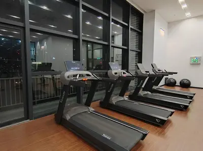 a row of treadmills in a gym with windows at Chambers Residence by FANTASTIC in Kuala Lumpur