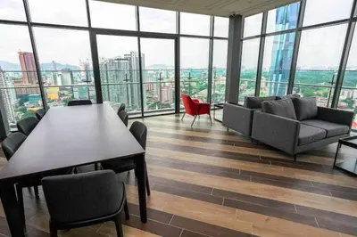 a large room with a table and chairs in a building at Ceylonz Suites KLCC, Bkt Bintang in Kuala Lumpur