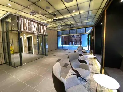 a waiting room with chairs and tables in a building at Ceylonz Suites KLCC, Bkt Bintang in Kuala Lumpur