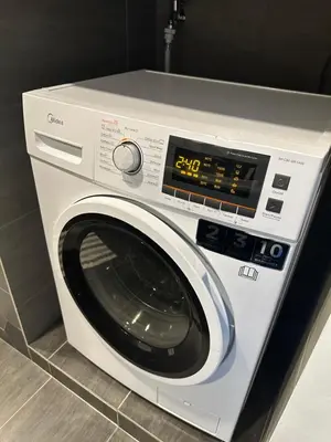 a white washing machine sitting in a kitchen at Ceylonz Suites KLCC, Bkt Bintang in Kuala Lumpur