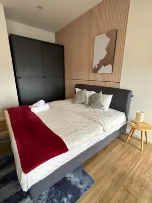 a bedroom with a large bed with a red blanket on it at Ceylonz Suites KLCC, Bkt Bintang in Kuala Lumpur