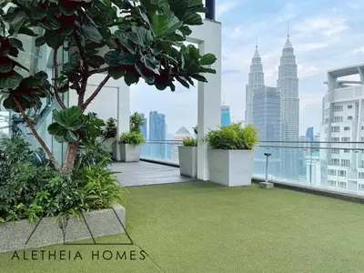 a balcony with plants and a view of the city at Aletheia Studio at KLCC in Kuala Lumpur