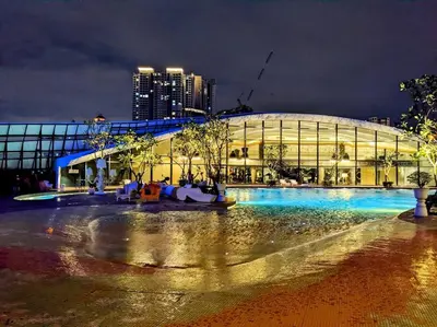 a large building at night with a building at Arte Mont Kiara in Kuala Lumpur