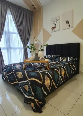 a bedroom with a bed with a colorful comforter at Arte Mont Kiara in Kuala Lumpur