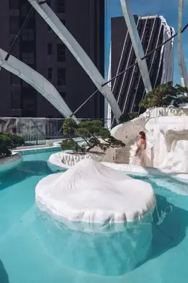 a woman in a wedding dress in a swimming pool at Arte Mont Kiara in Kuala Lumpur