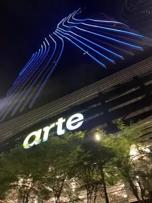 a sign on the side of a office building at night at Arte Mont Kiara in Kuala Lumpur