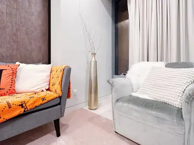 a living room with a chair and a vase at Tropicana The Residence Hermes Suite with KLCC View in Kuala Lumpur