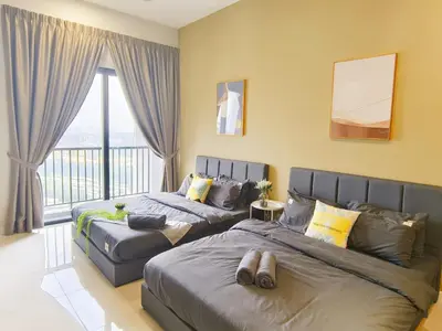 a bedroom with two beds and a balcony at Chambers Service Suites Amazing View KLCC in Kuala Lumpur