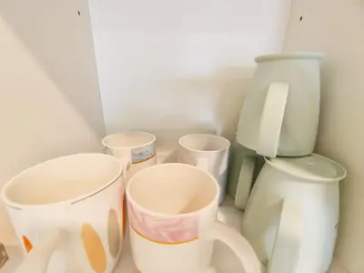 a group of cups and vases sitting on a counter at Chambers Service Suites Amazing View KLCC in Kuala Lumpur