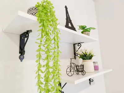 a white shelf with a green plant hanging from it at Chambers Service Suites Amazing View KLCC in Kuala Lumpur