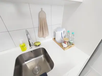 a kitchen counter with a sink and a towel at Chambers Service Suites Amazing View KLCC in Kuala Lumpur