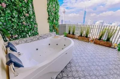 a bath tub in a bathroom with a view of the city at Penthouse Sky Jacuzzi At KLCC in Kuala Lumpur