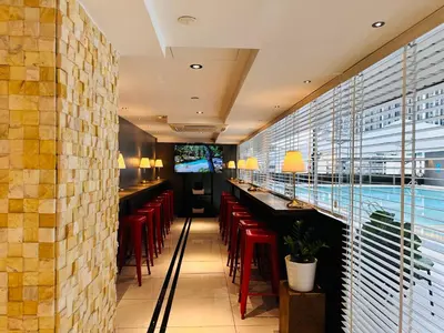 a restaurant with red chairs and a bar at The Bed Bukit Bintang in Kuala Lumpur