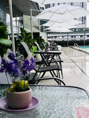 a patio with tables and chairs with flowers on it at The Bed Bukit Bintang in Kuala Lumpur