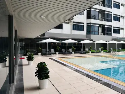 a hotel with a swimming pool and a building at The Bed Bukit Bintang in Kuala Lumpur