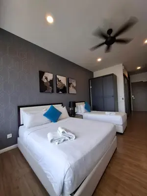 a bedroom with two beds and a ceiling fan at Ceylonz Suites By ANA MALAYSIA in Kuala Lumpur