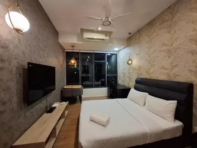 a hotel room with a bed and a television at Ceylonz Suites By ANA MALAYSIA in Kuala Lumpur