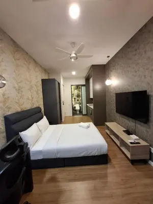 a bedroom with a bed and a flat screen tv at Ceylonz Suites By ANA MALAYSIA in Kuala Lumpur