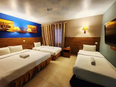 a hotel room with two beds and a tv at Boutique Hote123 in Kuala Lumpur