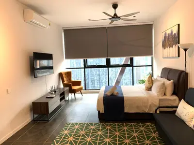 a bedroom with a bed and a large window at Scarletz Suites KLCC by GC Luxury Suites in Kuala Lumpur