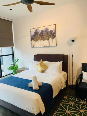 a bedroom with a large bed with a ceiling fan at Scarletz Suites KLCC by GC Luxury Suites in Kuala Lumpur