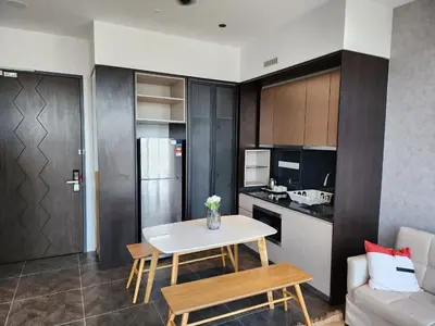 a kitchen and living room with a table and a couch at Scarletz Suites KLCC by GC Luxury Suites in Kuala Lumpur