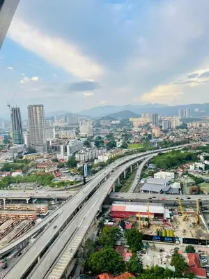 a city with a bridge over a highway at Scarletz Suites KLCC by GC Luxury Suites in Kuala Lumpur