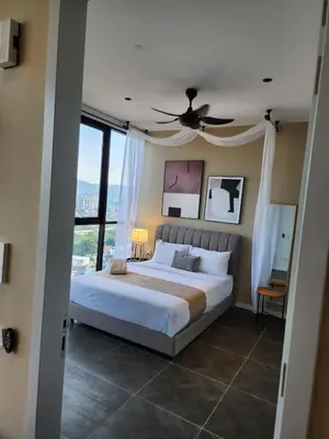 a bedroom with a large bed with a ceiling fan at Scarletz Suites KLCC by GC Luxury Suites in Kuala Lumpur