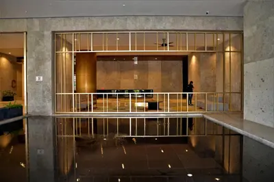 a lobby with a person walking in a building at Suasana Homestay Kewingston Platz in Kuala Lumpur